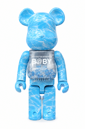 A blue Bearbrick toy with a water ripple pattern, a clear torso filled with beads, and "B@BY" text.