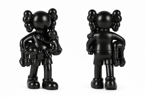 Two black KAWS Companion figures stand against a white background; one faces front, holding a smaller figure, and the other faces back.