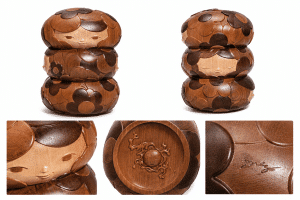 Two views of a three-tiered wooden doll with a carved face, hair, and floral patterns.