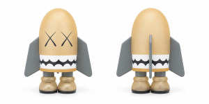 A tan bullet-shaped figure with black "XX" eyes, a white jagged mouth, gray fins, and tan boots.