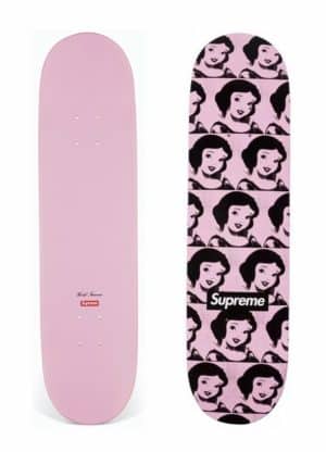 Two pink skateboards: one solid pink with "World Famous" and "Supreme" text, the other with a repeating Snow White pattern and "Supreme" text.