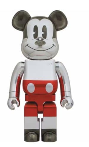 A chrome Mickey Mouse Bearbrick figure with a white torso, red shorts, and black ears and feet.