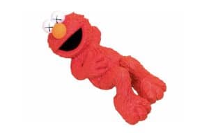 A red Elmo doll with white eyes, black X's for pupils, and an orange nose smiles on a white background.