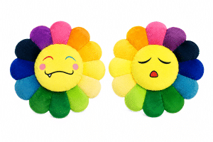 Two colorful plush flower pillows with yellow faces, one winking with a fang, the other with closed eyes and an open mouth.