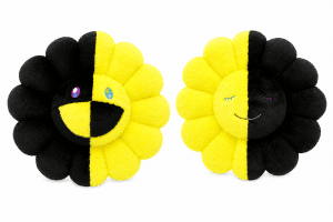 Two plush sunflower pillows, one with a wide smile and the other with a gentle smile, are split down the middle with black and yellow fur.