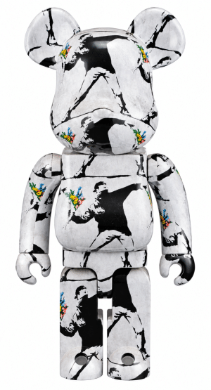 A white Bearbrick figure is covered in black Banksy "Flower Thrower" stencil art with colorful flowers.