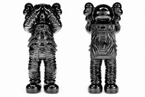 Two glossy black astronaut figurines, one facing forward and one backward, stand against a white background.