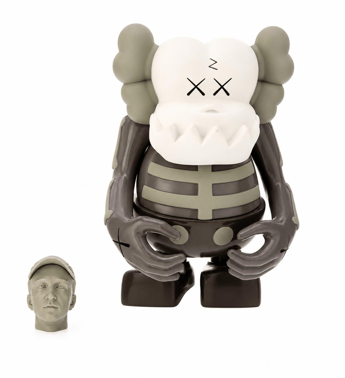 A KAWS Companion figure with a white skull face, "XX" eyes, and a gray skeleton body, next to a small gray head.