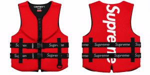 A red life vest with a black zipper and two black straps with "Supreme" written in white, on a white background.
