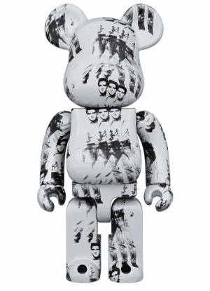 A white Bearbrick toy with black and white images of Elvis Presley from Andy Warhol's "Triple Elvis" artwork.