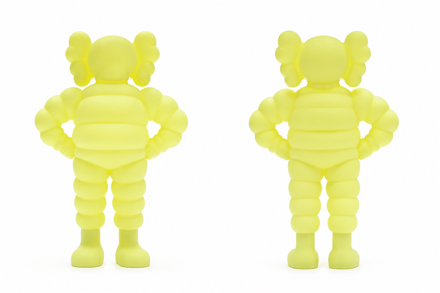 Two identical neon yellow Michelin Man figurines with "X" eyes, one facing forward and one facing backward.