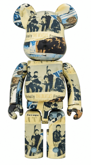 A Bearbrick figure is covered in black and white photos of The Beatles and text including "THE BEATLES."
