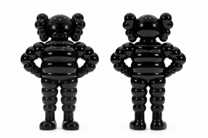 Two shiny black KAWS "What Party" vinyl figures stand side-by-side against a white background.