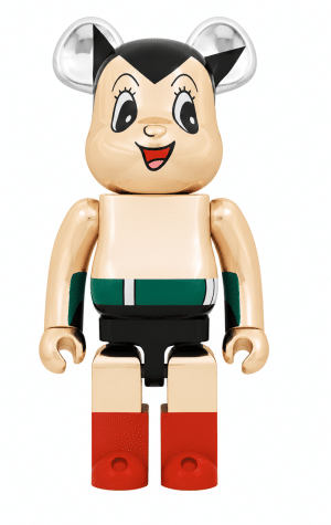 A shiny gold and black Be@rbrick figure with large silver ears, red boots, and a green and white striped belt.
