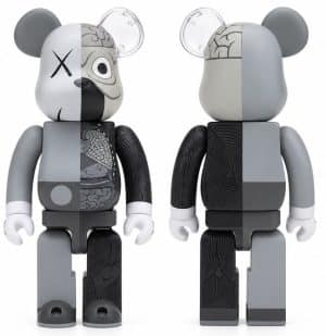 Two gray and black KAWS dissected Be@rbrick figures are shown, one from the front and one from the back.