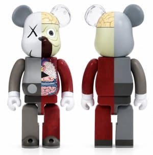 Two KAWS Companion bear figures are shown, one displaying internal organs and the other a solid color.
