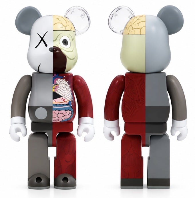 Two KAWS Companion bear figures are shown, one displaying internal organs and the other a solid color.
